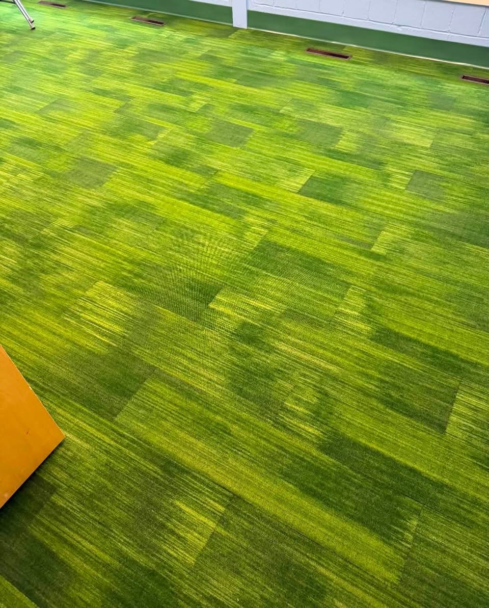 Green grass-look carpet tile, special-ordered for school classrooms.