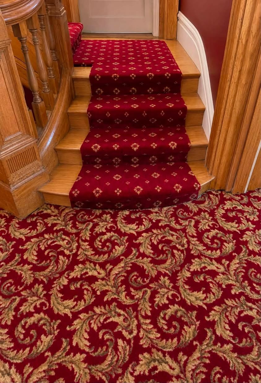 A red patterned stair runner and matching carpet in a historic home in downtown Louisville.