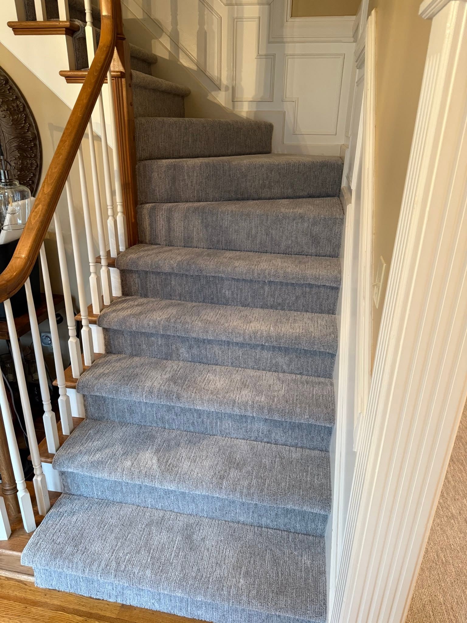 An elegant gray stair runner in a formal staircase.