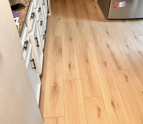 AeroCore flooring in the color Illusion Oak, in a kitchen.