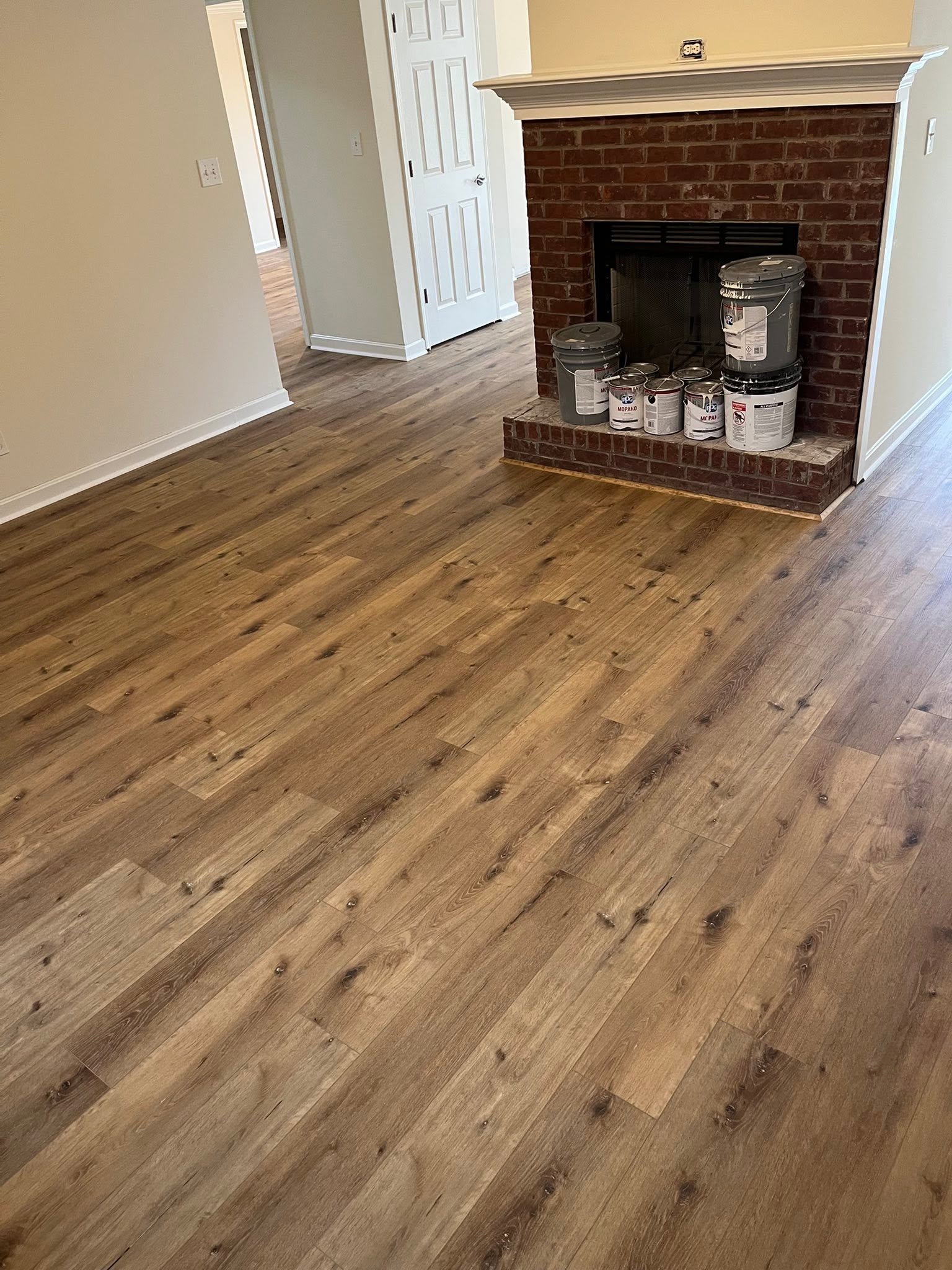 AeroCore flooring in the color Illusion, in a living room with a brick fireplace.