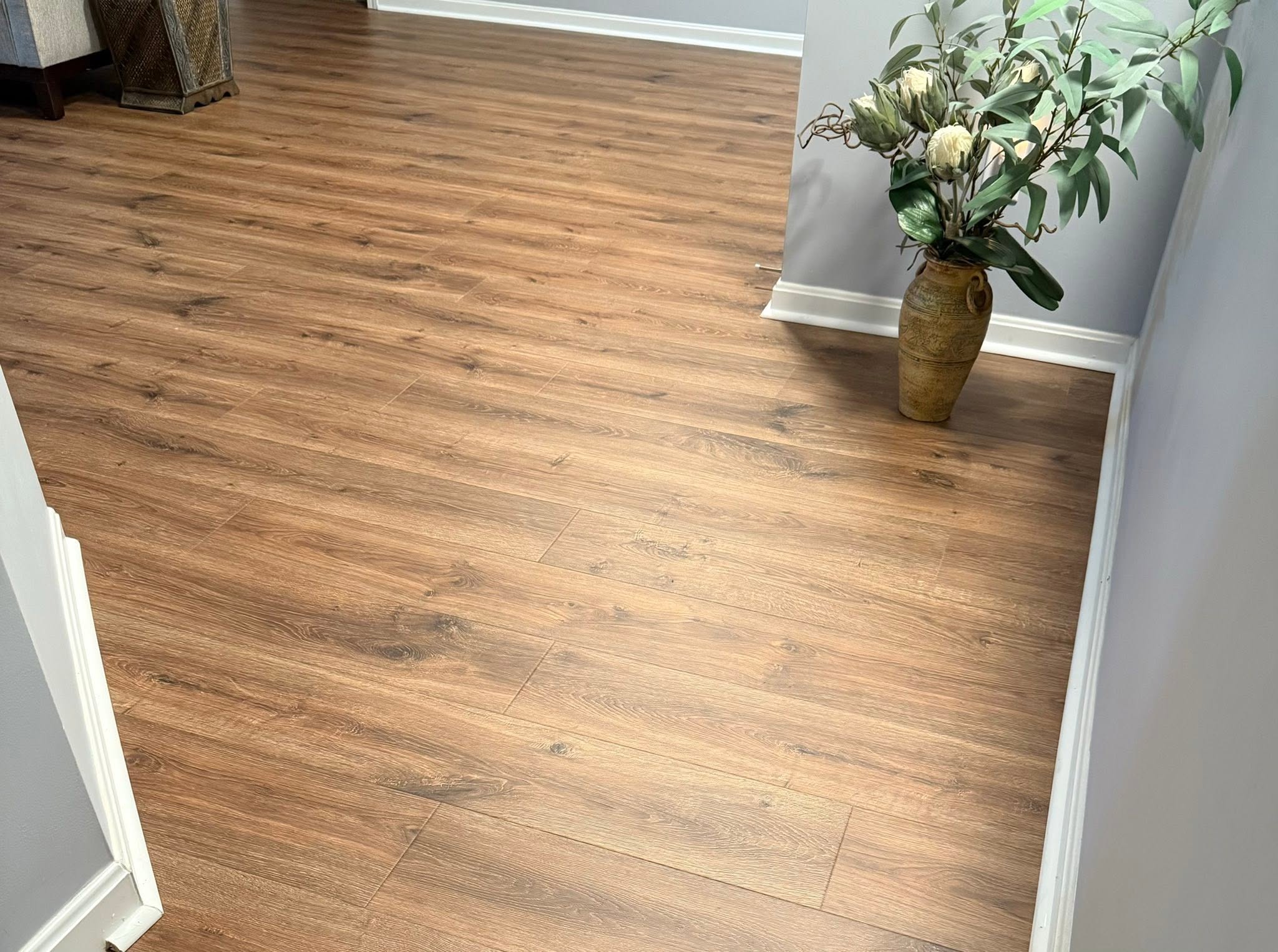 Whitewashed wide-plank wood-look flooring in an entry hallway.