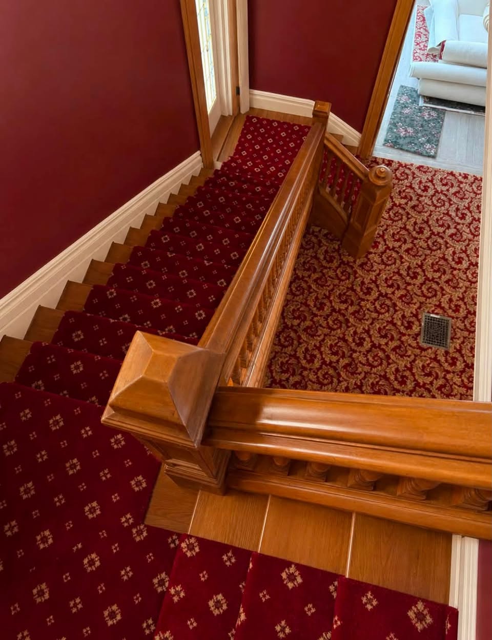 Red patterned carpet on the staircase of a historic home in downtown Louisville.